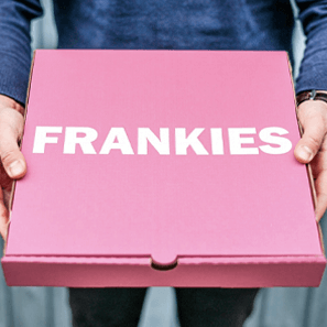 A pink pizza box with the Frankies white logo.